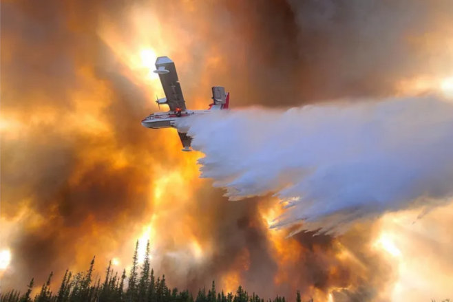  Eric Kiehn (Alaska’s Northwest Incident Management Team 10)/Alaska Division of Forestry's photo: airplane dropping water on the Clear Fire. (Anderson, Alaska) (July 6, 2022) via AP/Chicago Sun-Times