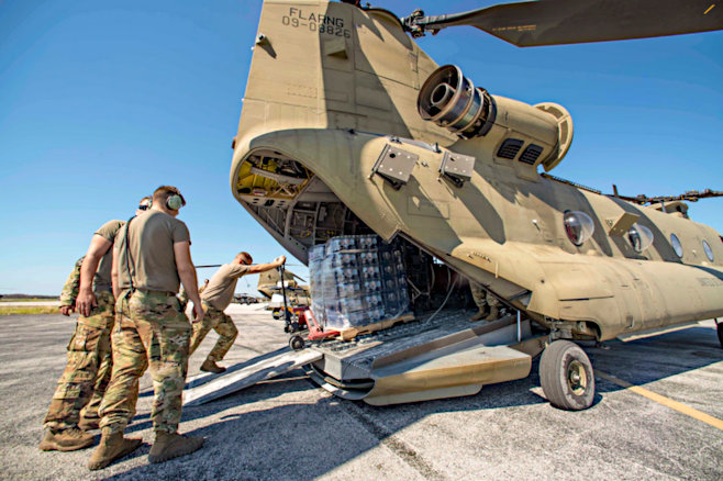 Air Force Senior Airman Jesse Hanson's photo: Florida National Guardsmen loading water into an Army Chinook helicopter. Fort Myers, Florida, responding to Hurricane Ian. (October 3, 2022) From DOD, used w/o permission.