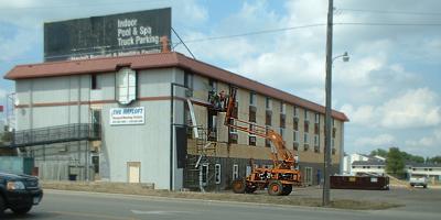 Off with the old siding of the Super 8 motel building